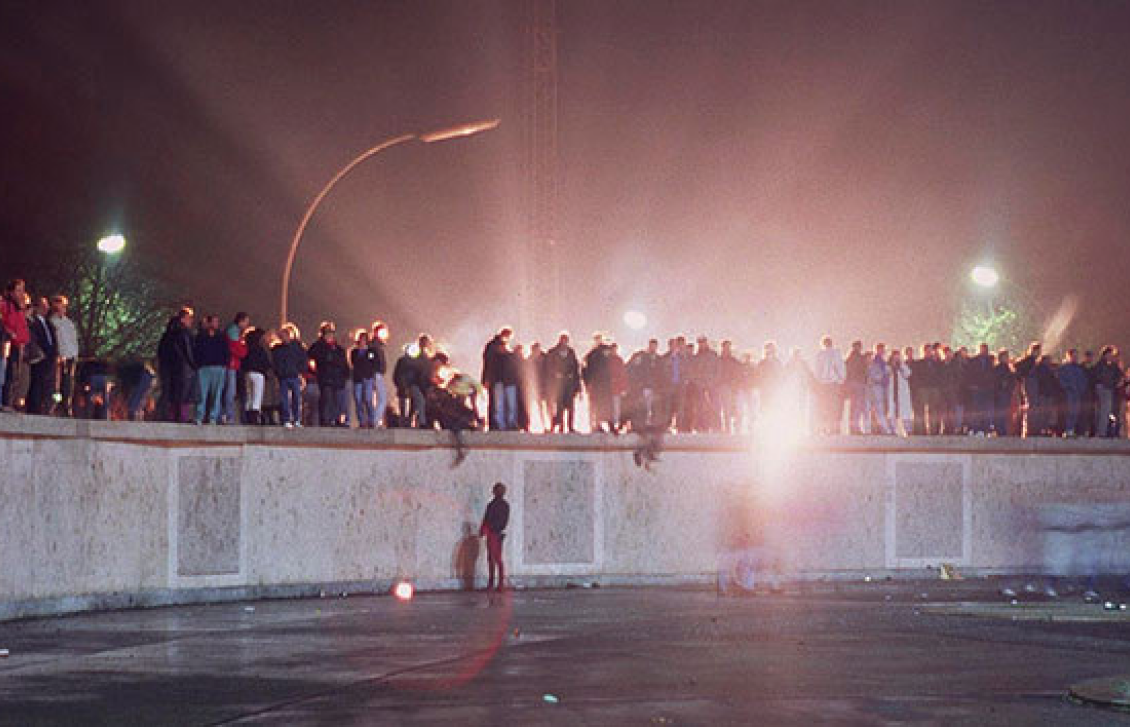 people standing on Berlin Wall at night people standing on Berlin Wall at night