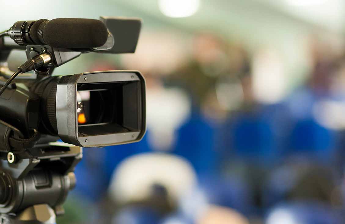 tv news camera with blurred background
